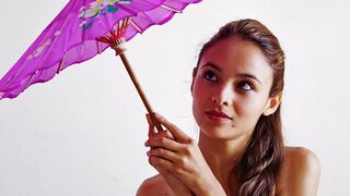 Fedra toying her cunt with a purple parasol